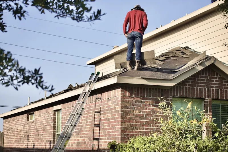 Professional roofer working on a residential roof in Mason Estates